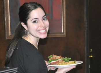 Julia serves lunch with a smile.