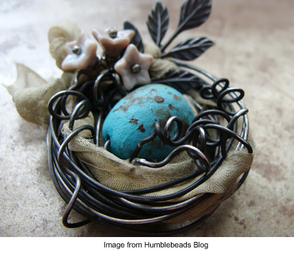 tiny bird's nest made from wire with blue egg bead