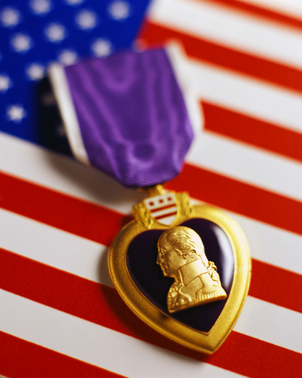 Purple Heart medal laying on the American Flag