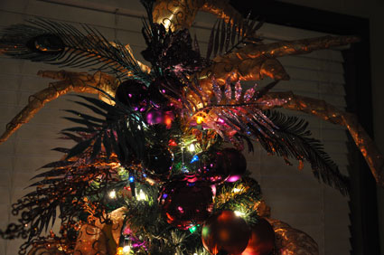 glittered leaves, feathers and ribbons spires make up the tree topper