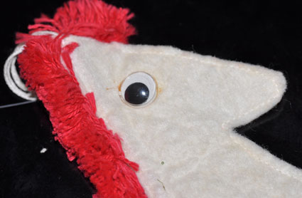 Felt horse head ornament with googly eyes.