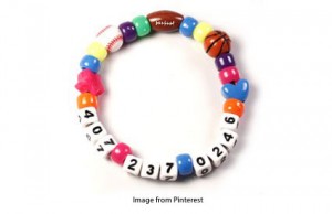 numbered beads creating a bracelet with phone number for small children